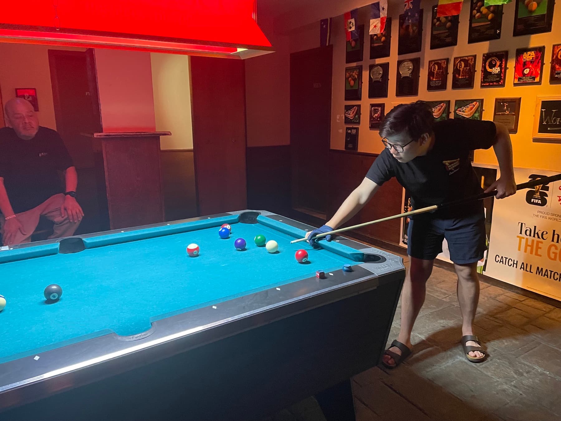 A Zingage teammate playing pool at night